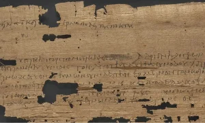 Μια σαρωμένη εικόνα του Πάπυρου 1185, ενός αρχαίου χειρογράφου που χρονολογείται πριν από 1826 χρόνια, με χειρόγραφη ελληνική γραφή σε ένα φθαρμένο κομμάτι παπύρου, πιθανώς δίπλωμα ή επίσημο έγγραφο από την αρχαιότητα. Πίστωση: Μεσαιωνικά Χειρόγραφα X, προφίλ X